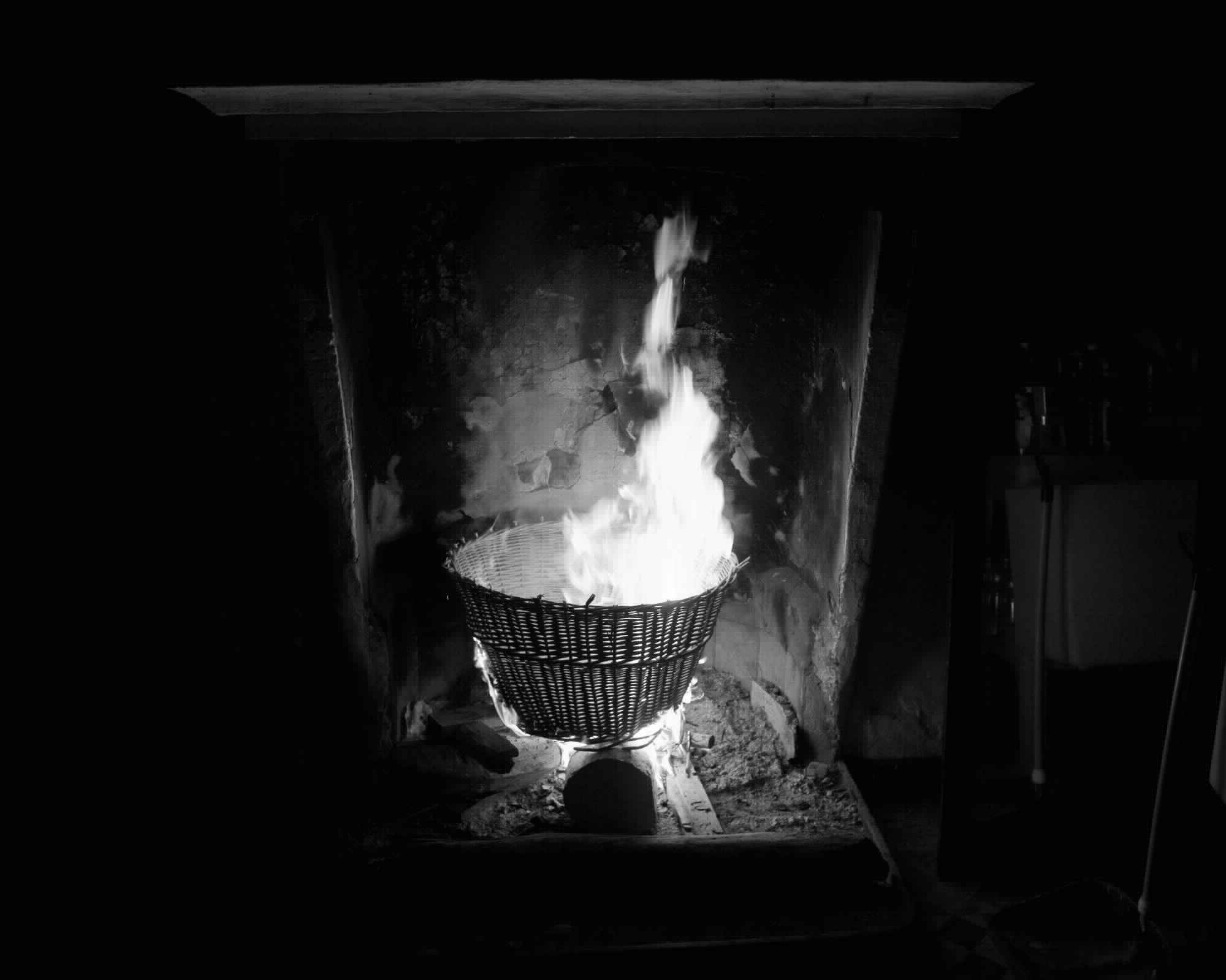 four photographs of burning objects in a fireplace